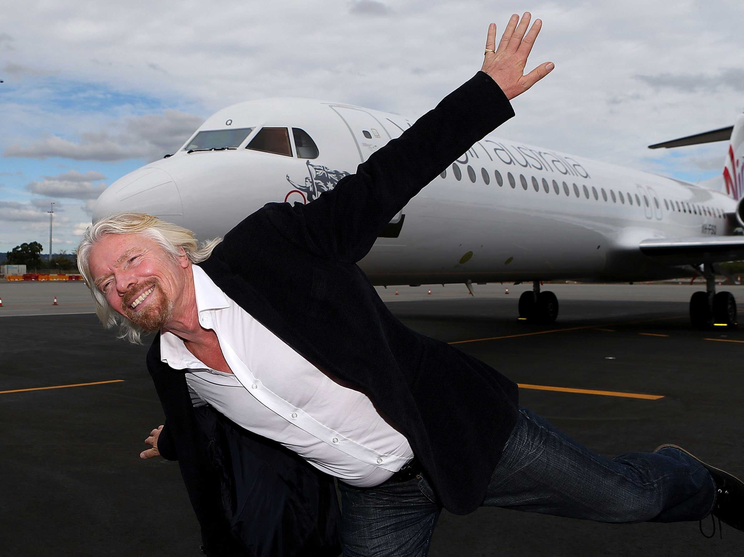 sir richard branson in front of a jet