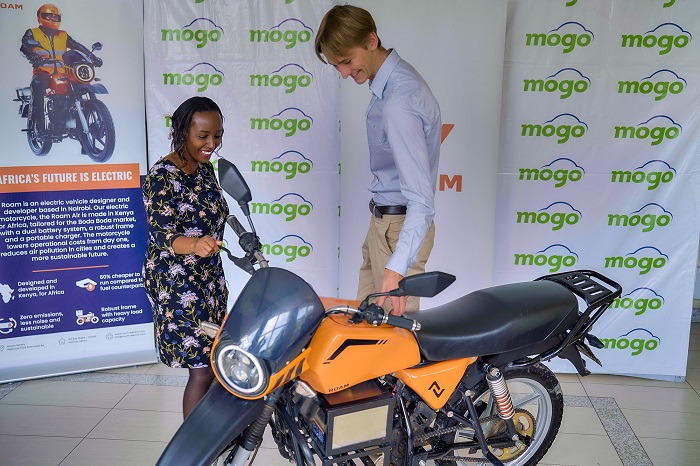 picture of a mogo and roam representatives with roam electric motorbike