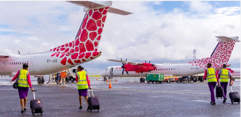 a pic of people boarding jambojet planes on the runway in kenya