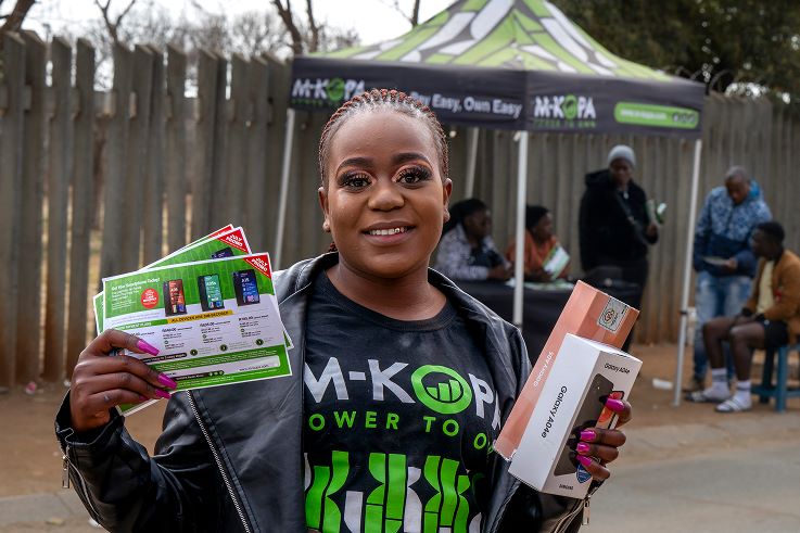picture of an m-opa vendor with some of the loan products they sell.